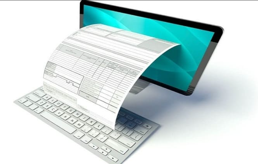 The image shows a digital concept where an electronic document or invoice appears to be emerging from a computer screen. The document is detailed with lines and sections typical of a traditional invoice, and it seems to flow out of the screen onto the keyboard. The computer screen has a turquoise background, suggesting a modern and sleek digital interface. The image emphasizes the transition from paper-based to digital invoicing, highlighting efficiency and technological advancement in document management