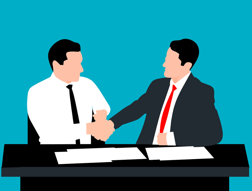 Illustration of two businessmen shaking hands across a desk. Both men are dressed in formal attire, one in a white shirt and black tie, the other in a dark suit and red tie. Papers are scattered on the desk, suggesting a formal agreement or deal being made. The blue background highlights the professional and cooperative nature of the interaction.